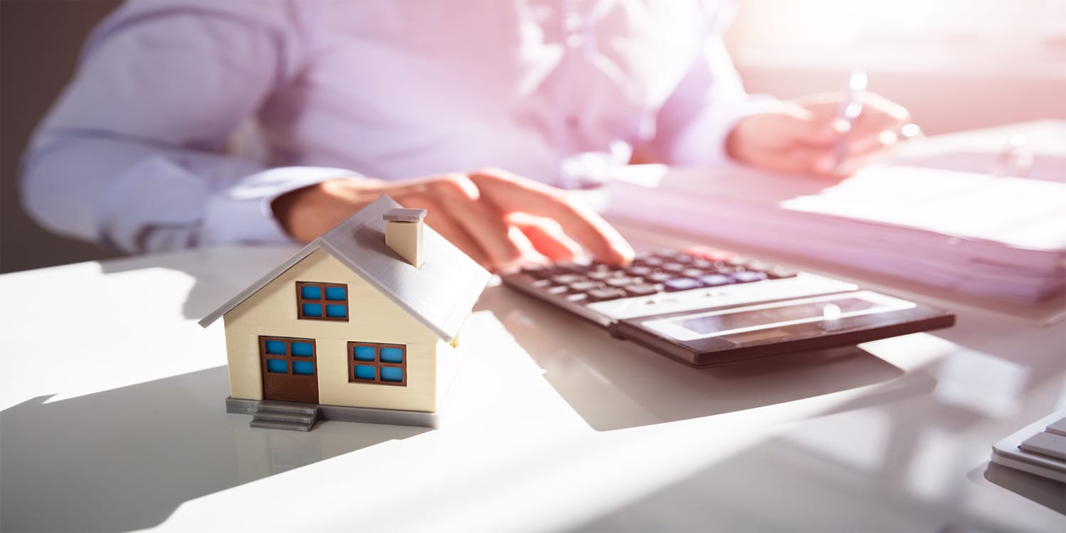 Real estate agent with calculator, cost to sell house concept